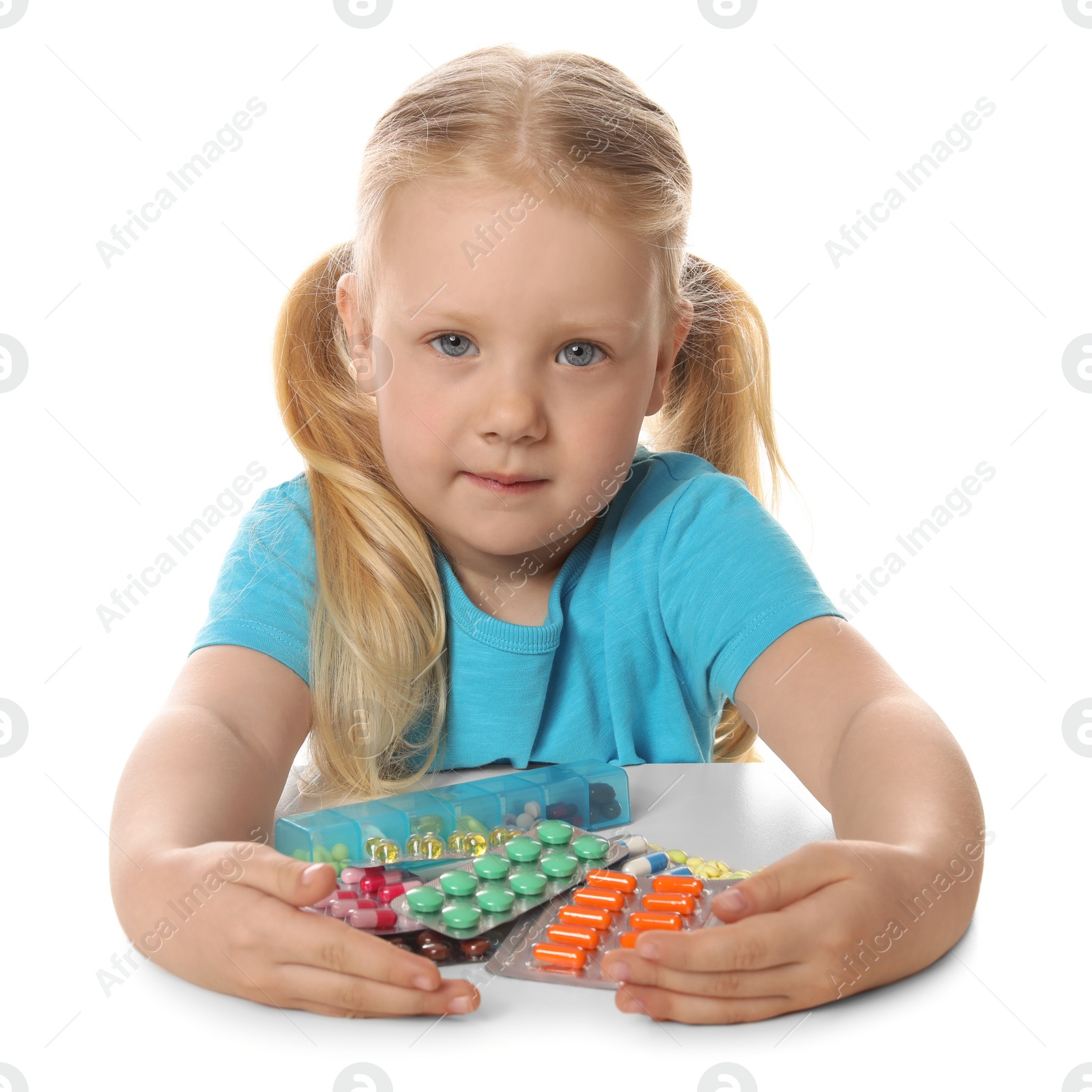 Photo of Little child with many different pills on white background. Danger of medicament intoxication