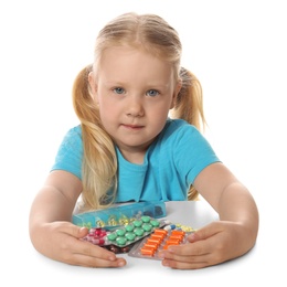 Little child with many different pills on white background. Danger of medicament intoxication