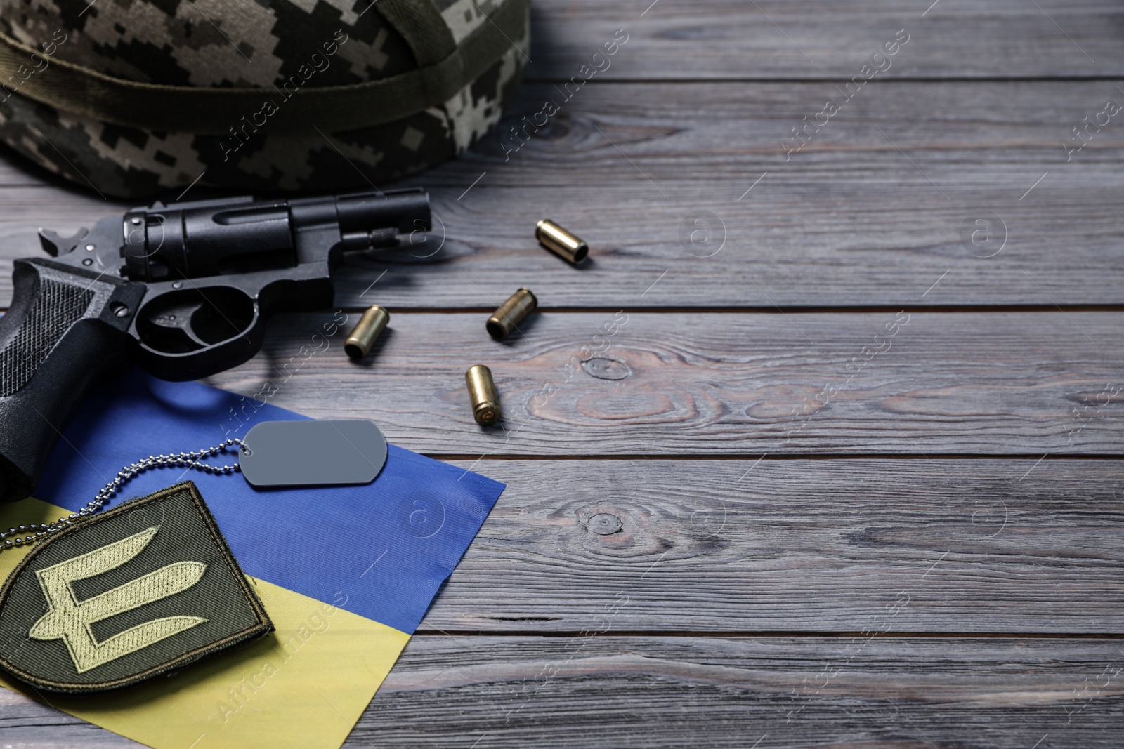 Photo of MYKOLAIV, UKRAINE - SEPTEMBER 19, 2020: Composition with Ukraine military equipment on grey wooden table, space for text