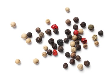 Aromatic spices. Pile of different peppers isolated on white, top view