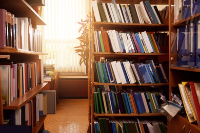 Collection of different books on shelves in library