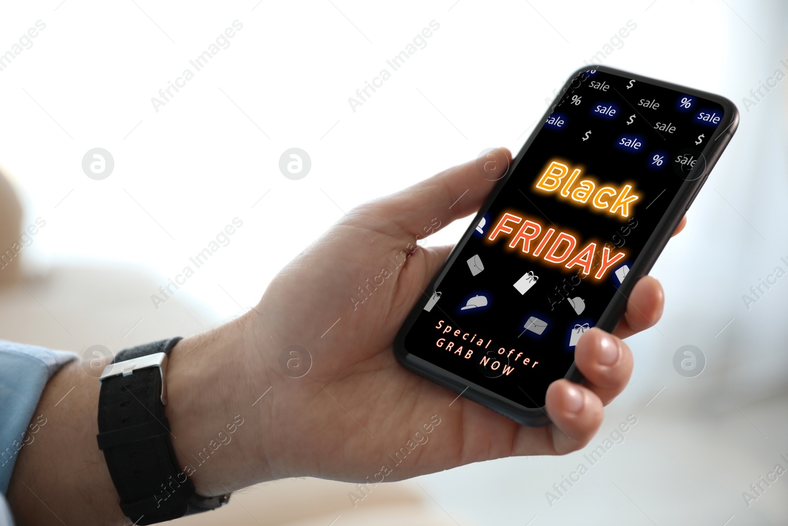 Image of Black Friday. Man shopping online using smartphone, closeup