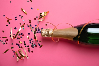 Photo of Creative flat lay composition with bottle of champagne on color background