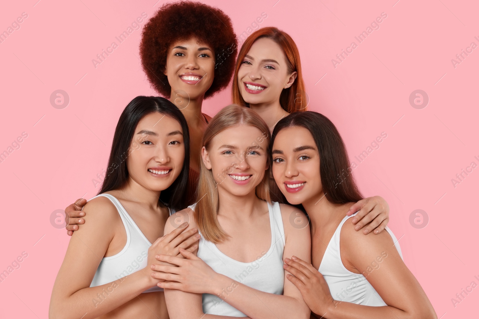 Photo of Portrait of beautiful young women on pink background