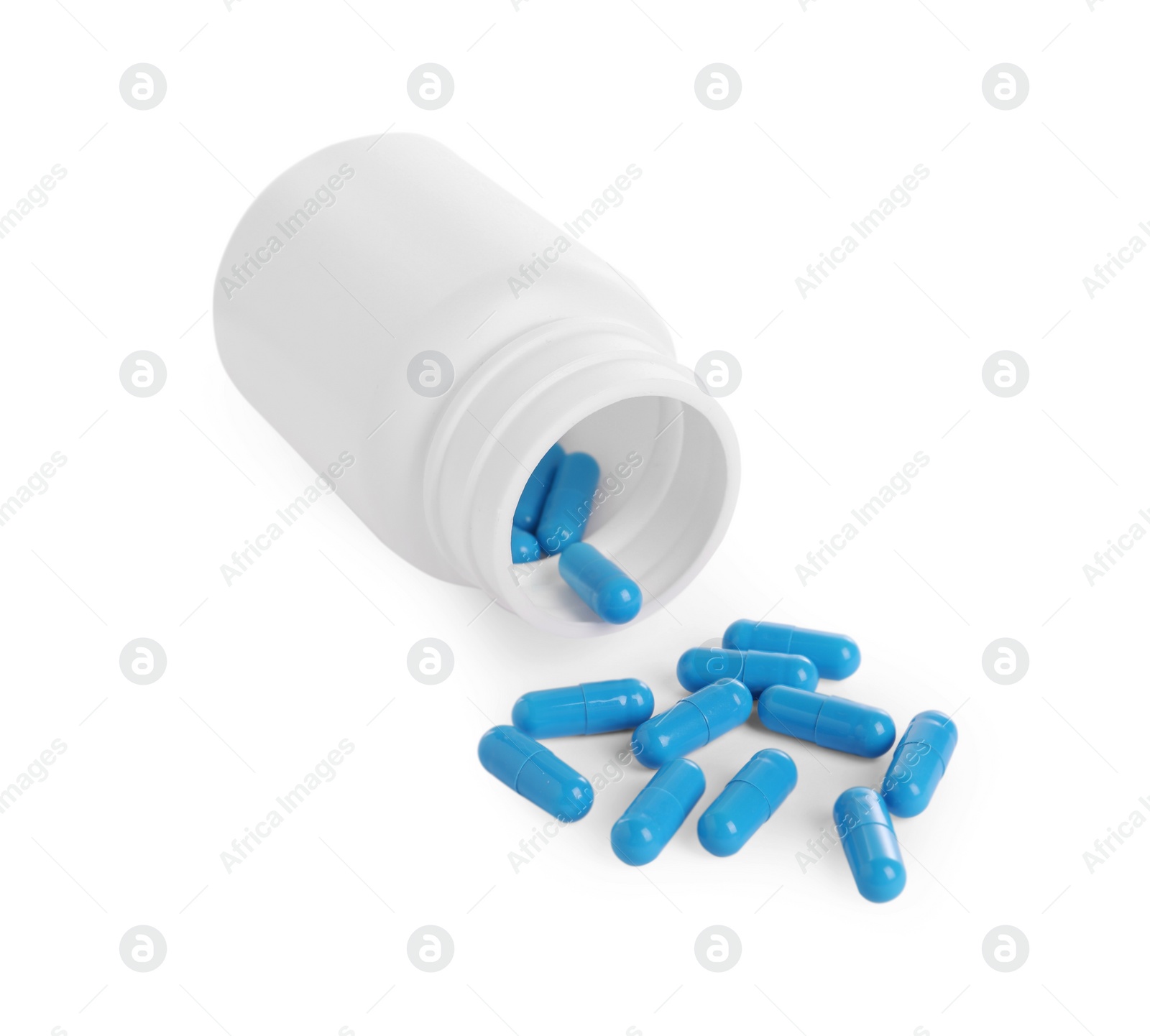 Photo of Medical bottle and blue pills on white background