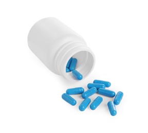 Medical bottle and blue pills on white background