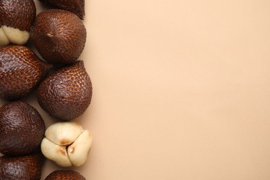 Fresh salak fruits on beige background, flat lay. Space for text