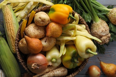 Photo of Different fresh ripe vegetables and fruits on grey wooden table, closeup