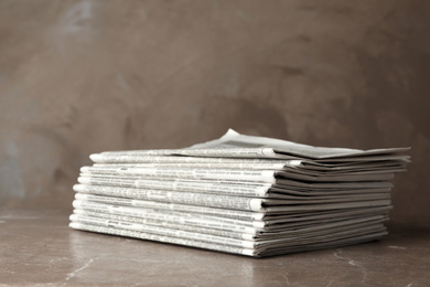 Stack of newspapers on marble table. Journalist's work