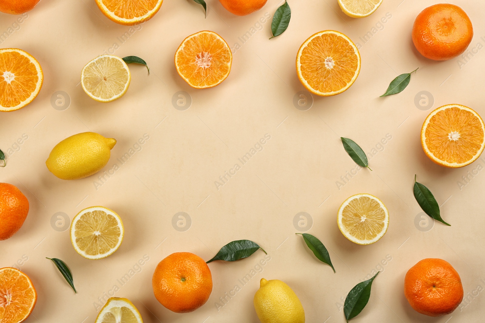 Photo of Flat lay composition with tangerines and different citrus fruits on beige background. Space for text