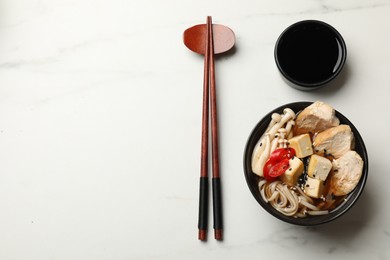 Photo of Delicious ramen served on white marble table, flat lay with space for text. Noodle soup