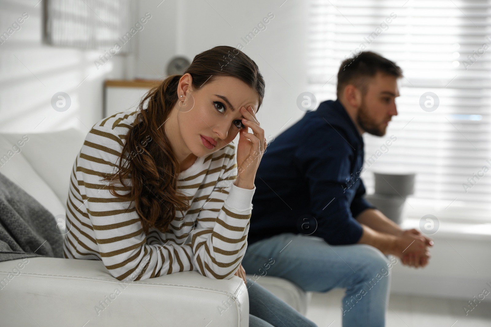 Photo of Young couple quarreling at home. Jealousy in relationship