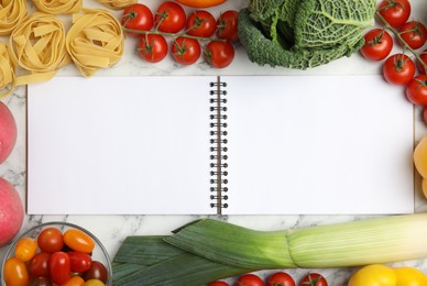 Photo of Recipe book surrounded by different ingredients on white marble table, flat lay with space for text. Cooking classes