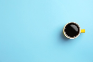 Photo of Ceramic cup with hot aromatic coffee on color background, top view