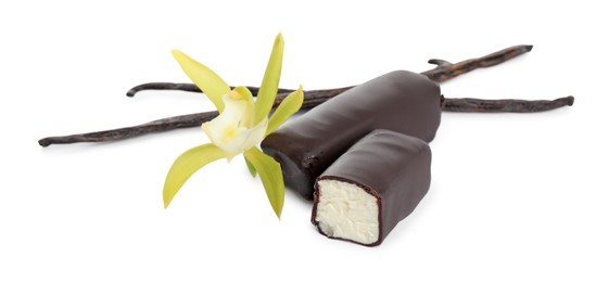 Photo of Glazed curd cheese bars, vanilla pods and flower isolated on white