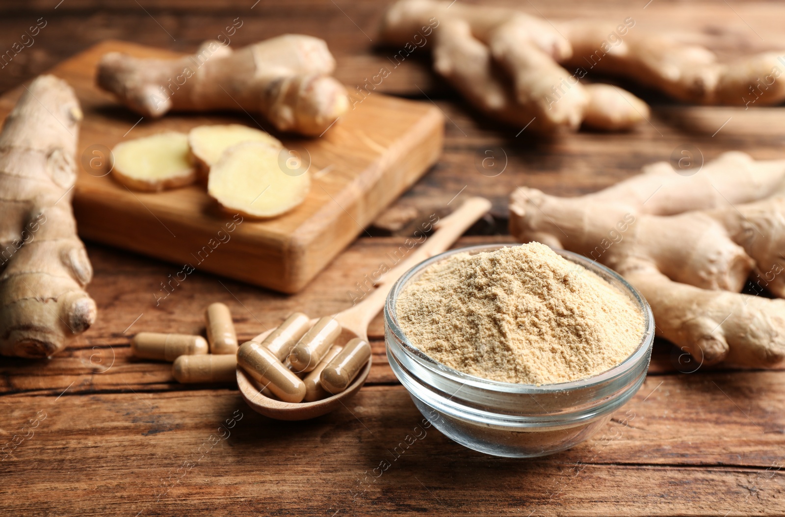 Photo of Dry, fresh and capsuled ginger on wooden table