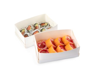 Photo of Food delivery. Paper boxes with different delicious sushi rolls on white background