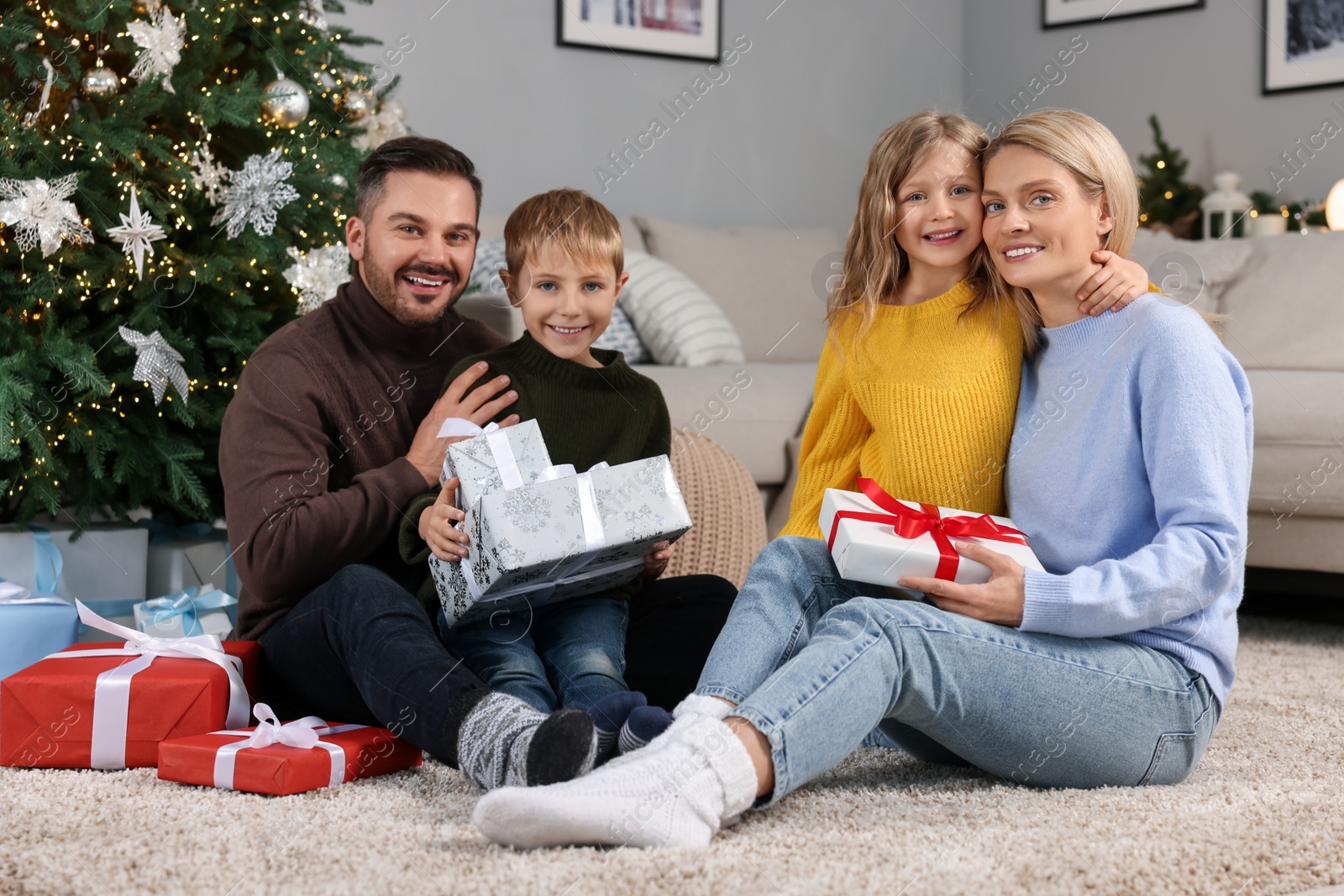 Photo of Happy family with Christmas gifts at home