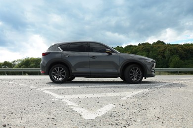 Photo of New black modern car on asphalt road