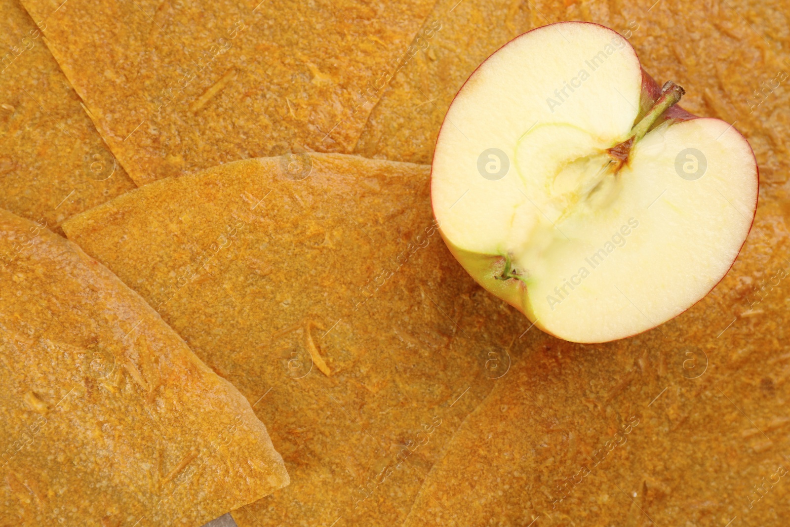 Photo of Apple on delicious fruit leather, top view. Space for text