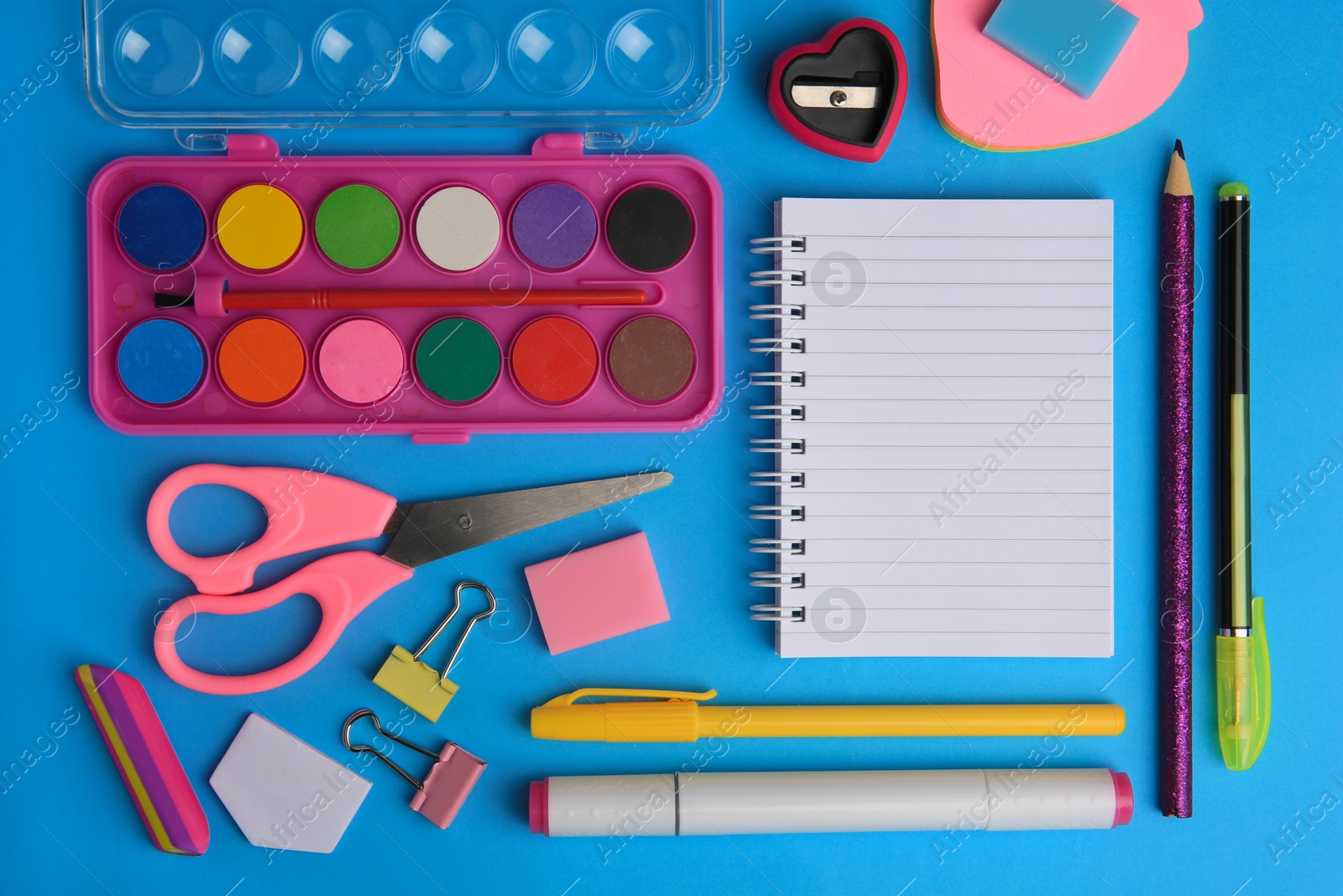 Photo of Flat lay composition with blank notebook and other school stationery on light blue background, space for text. Back to school