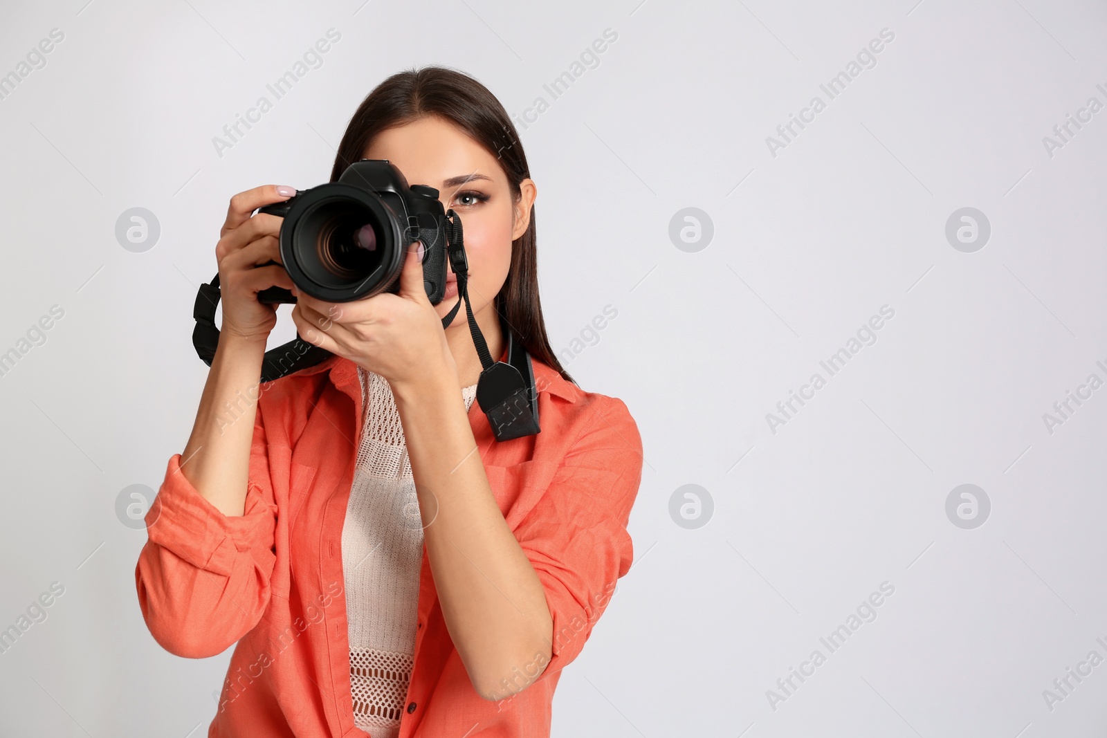 Photo of Professional photographer working on white background in studio