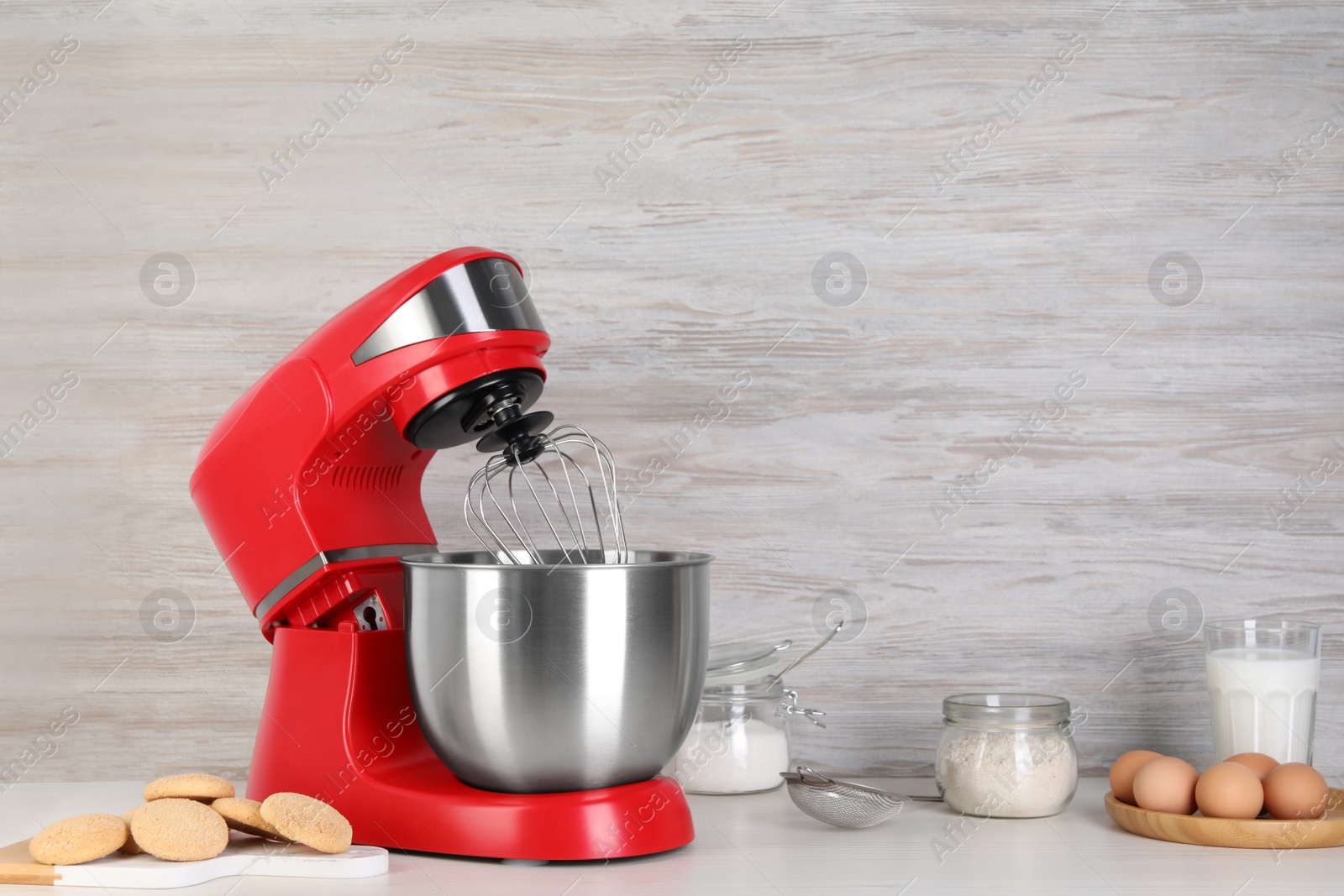 Photo of Composition with modern red stand mixer and different products on white table