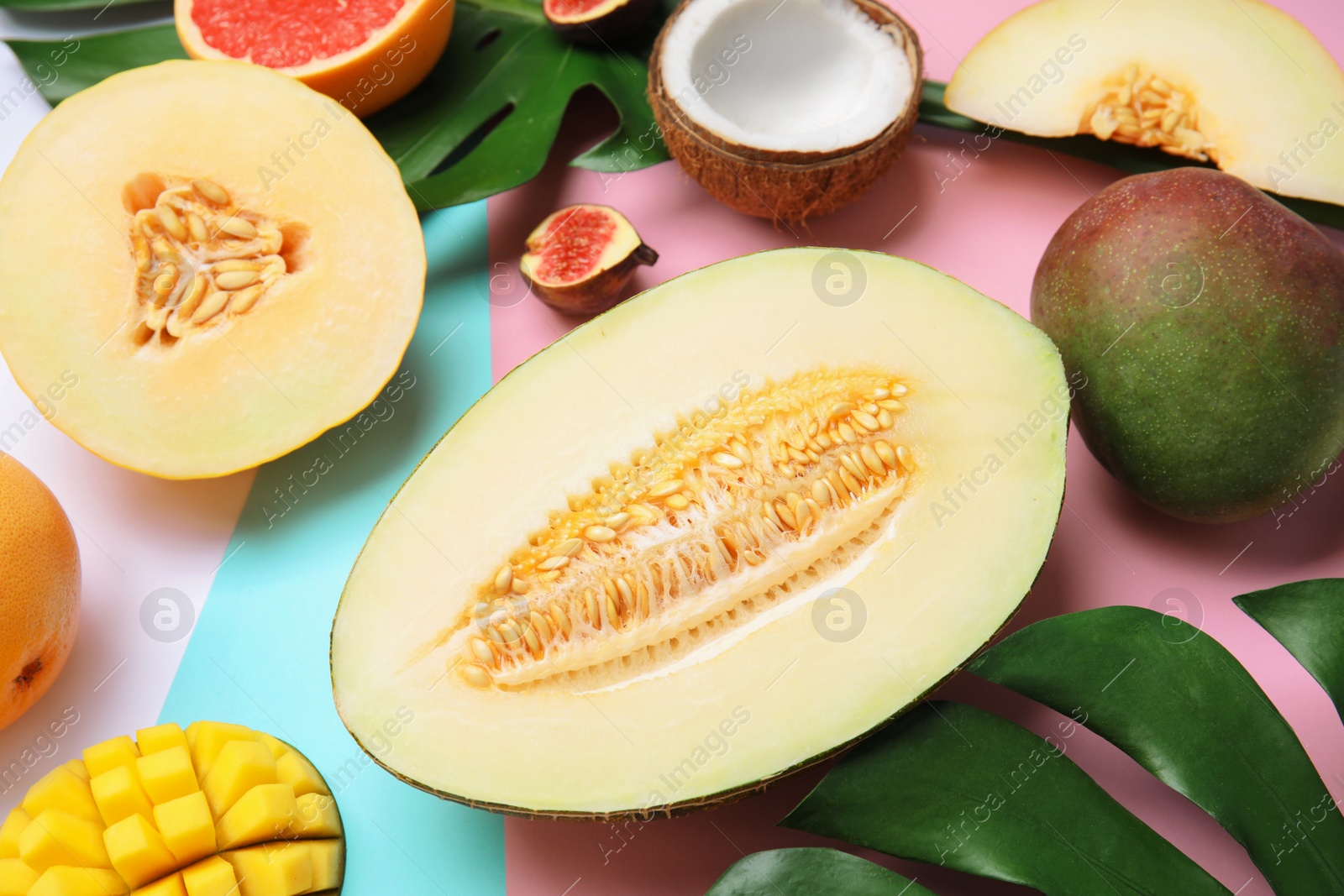 Photo of Juicy melon and other fruits on color background