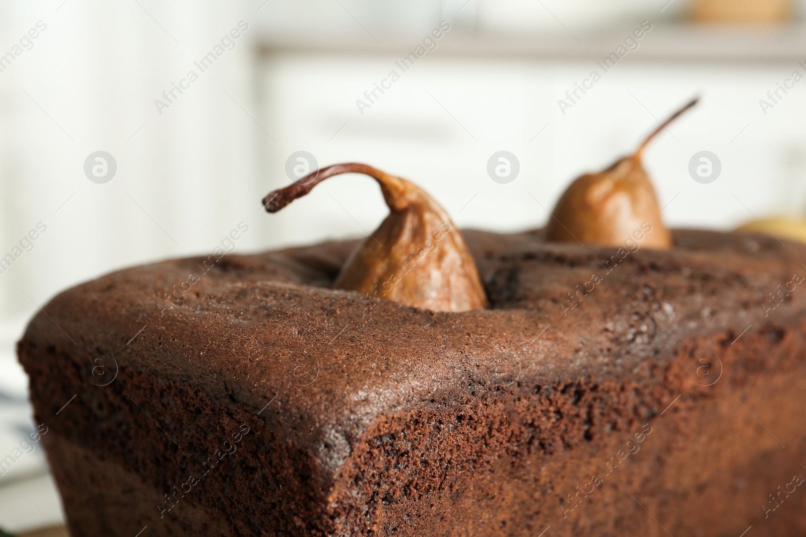 Photo of Tasty chocolate pear bread against blurred background, closeup. Homemade cake