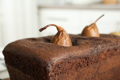 Photo of Tasty chocolate pear bread against blurred background, closeup. Homemade cake