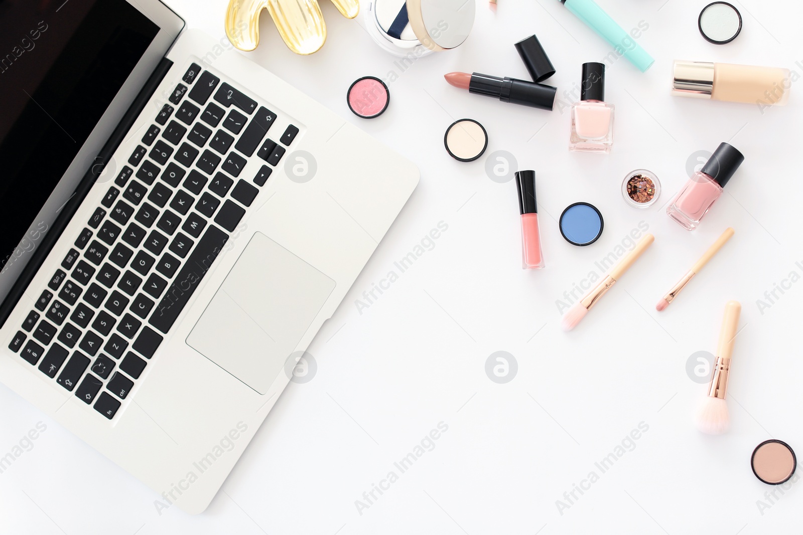 Photo of Flat lay composition with makeup products for woman and laptop on white background