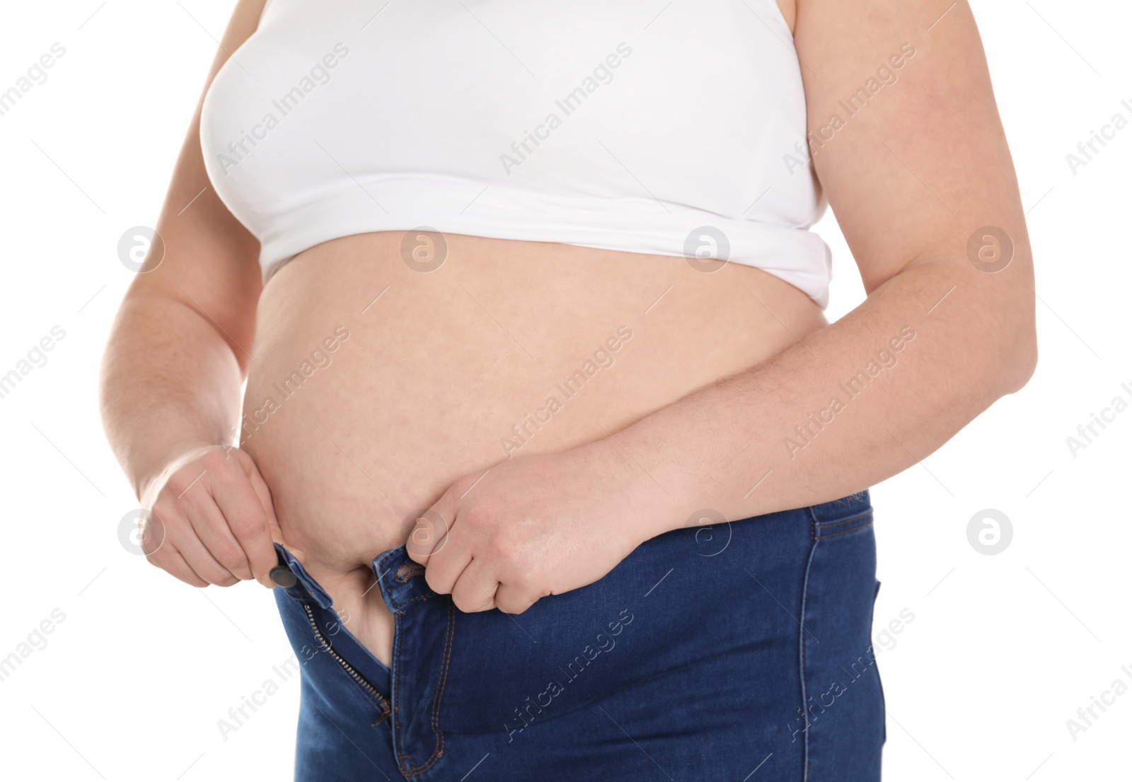 Photo of Overweight woman trying to wear tight jeans isolated on white, closeup