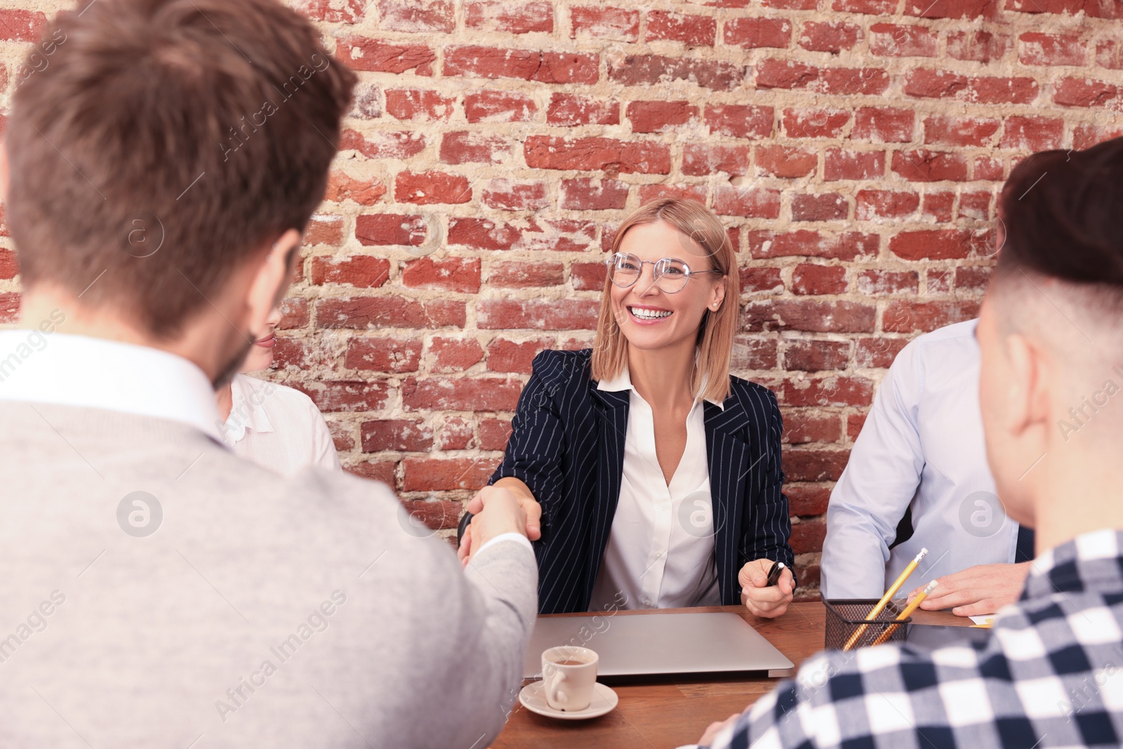 Photo of Businesswoman having meeting with her employees in office. Lady boss