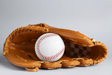 Photo of Catcher's mitt and baseball ball on white background. Sports game