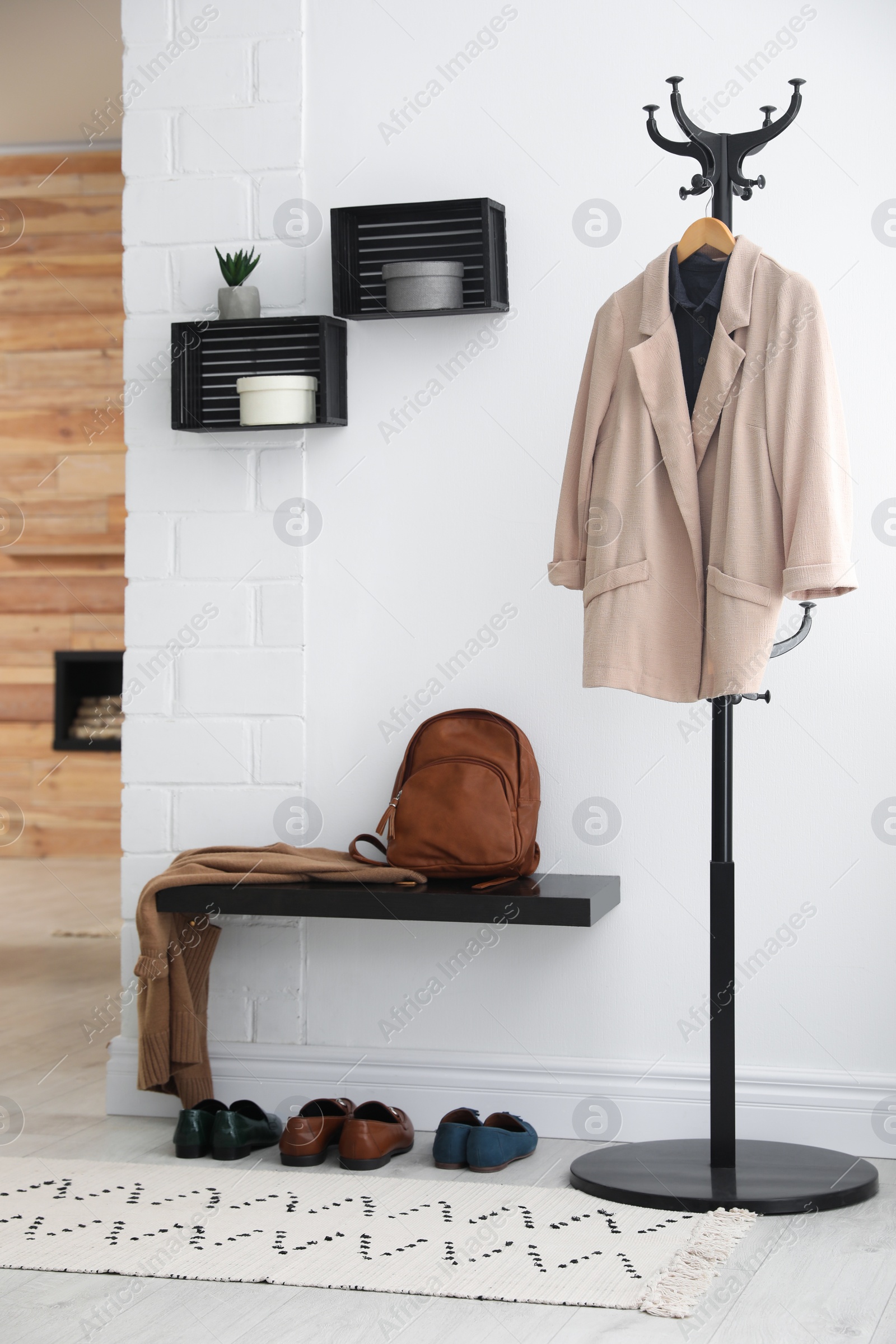 Photo of Hallway interior with stylish furniture, clothes and accessories