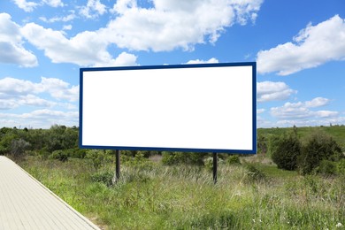 Image of Empty signboard near road outdoors. Mock-up for design