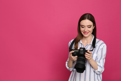 Professional photographer with modern camera on pink background. Space for text