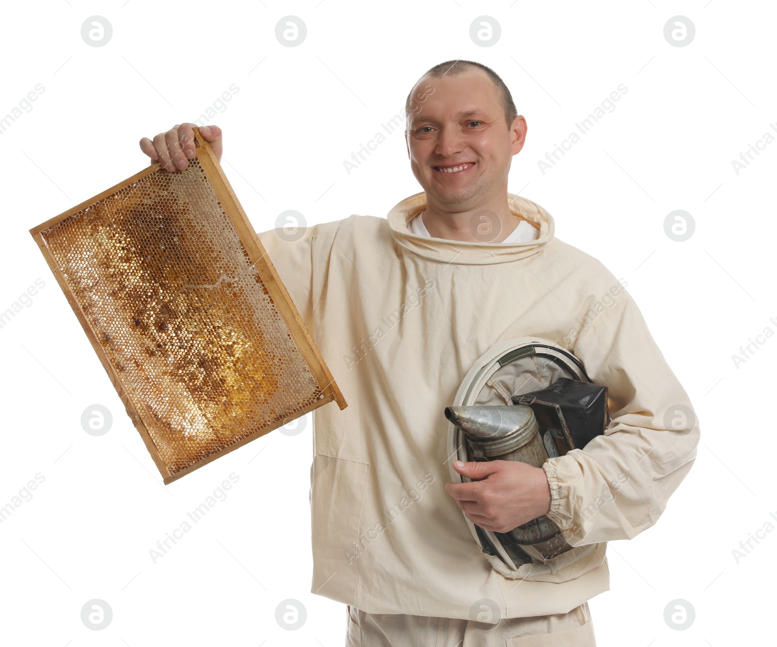 Photo of Beekeeper in uniform holding smokepot and hive frame with honeycomb on white background