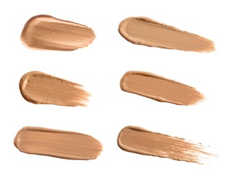 Image of Set with different shades of liquid skin foundation on white background, top view 