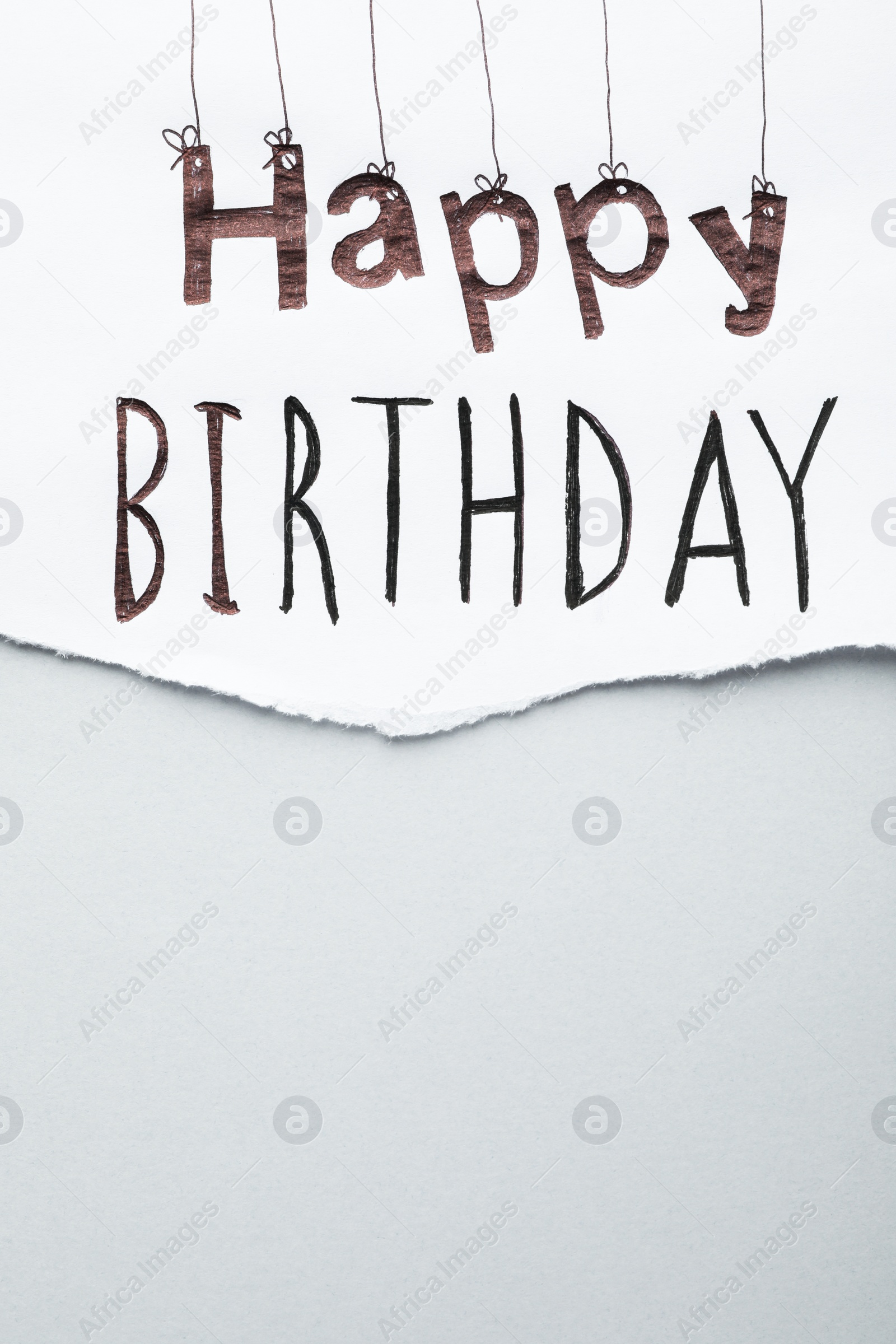 Photo of Sheet of paper with words HAPPY BIRTHDAY on light grey background, top view. Space for text