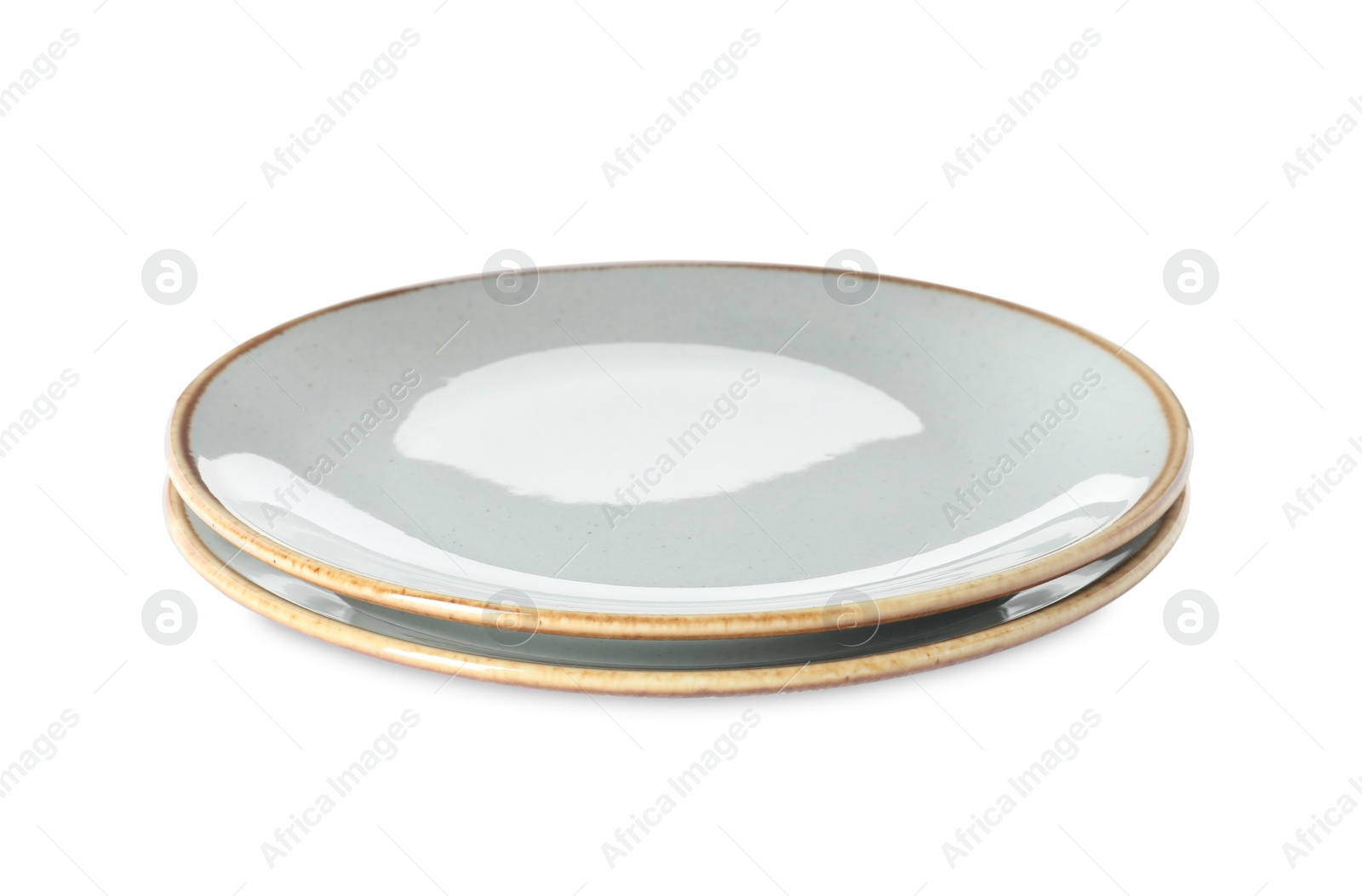 Photo of New ceramic plates on white background. Tableware