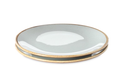 New ceramic plates on white background. Tableware