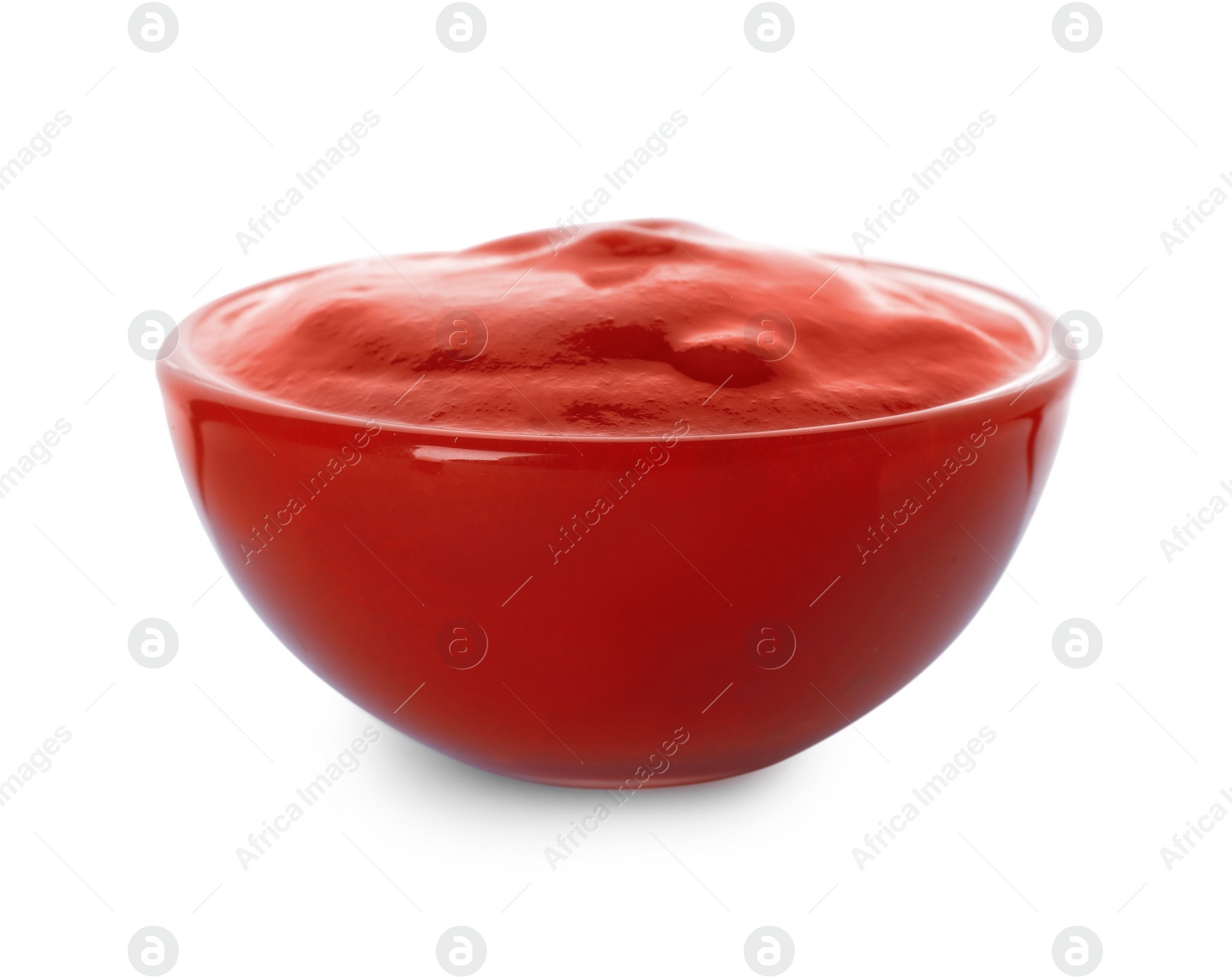 Photo of Glass bowl with red sauce isolated on white