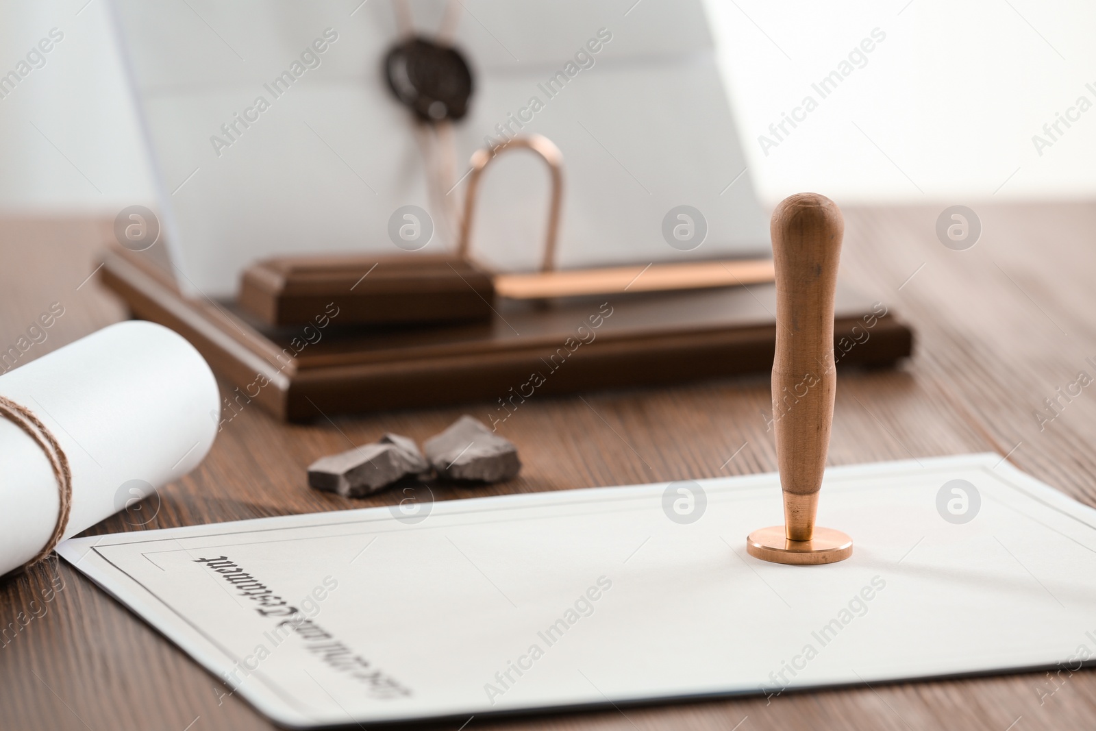 Photo of Vintage notary stamp and documents on wooden table