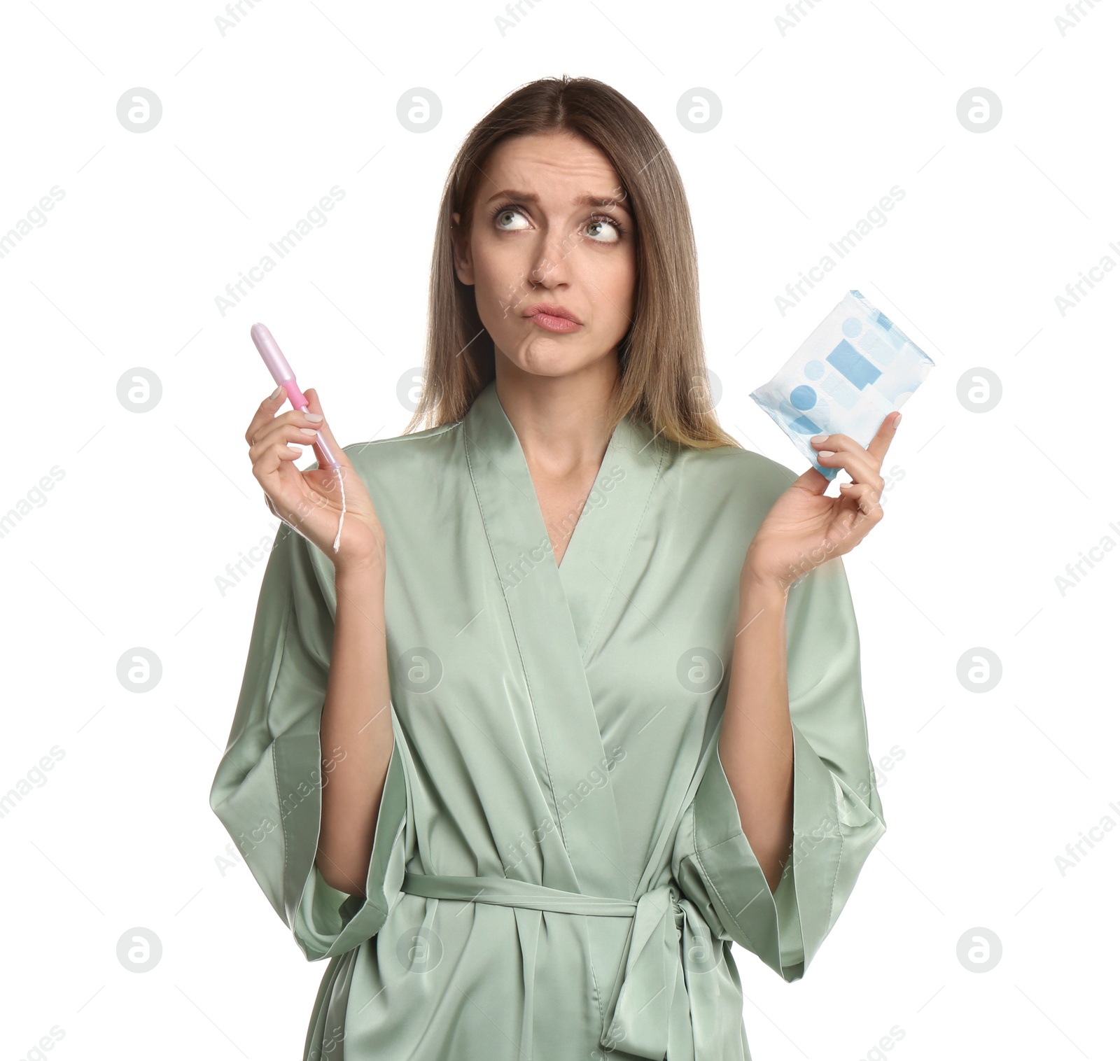 Photo of Thoughtful young woman with disposable menstrual pad and tampon on white background