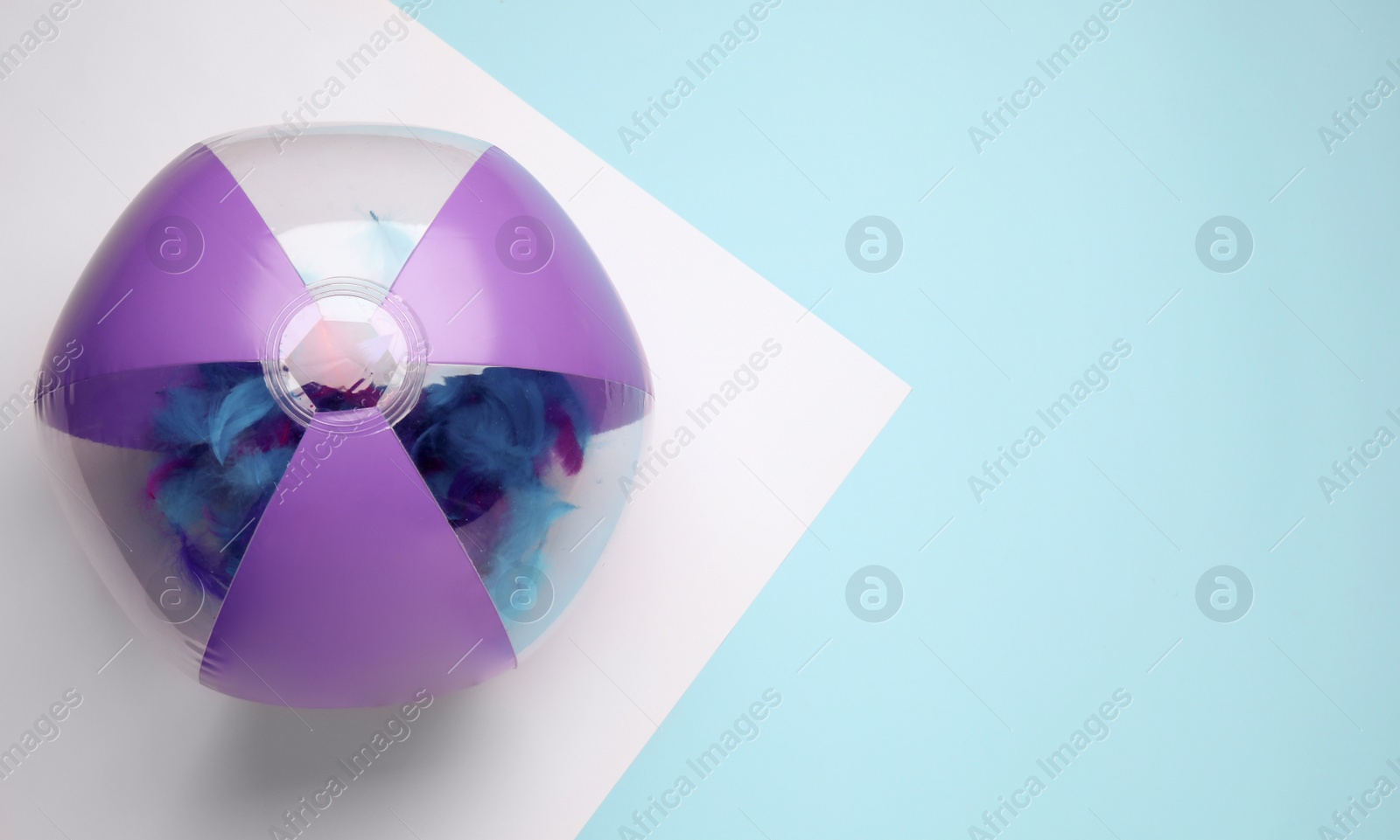 Photo of Bright beach ball on color background, top view. Space for text