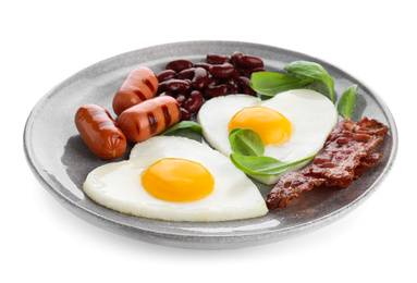 Plate of tasty breakfast with heart shaped fried eggs isolated on white