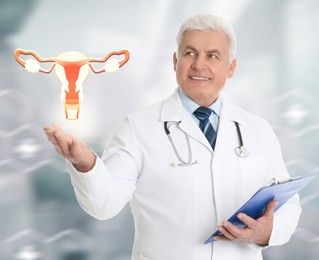 Image of Senior doctor demonstrating virtual icon with illustration of female reproductive system on light background. Gynecological care 