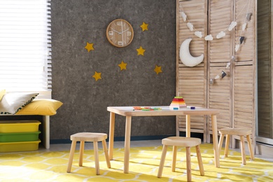 Baby room interior with wooden furniture and toys