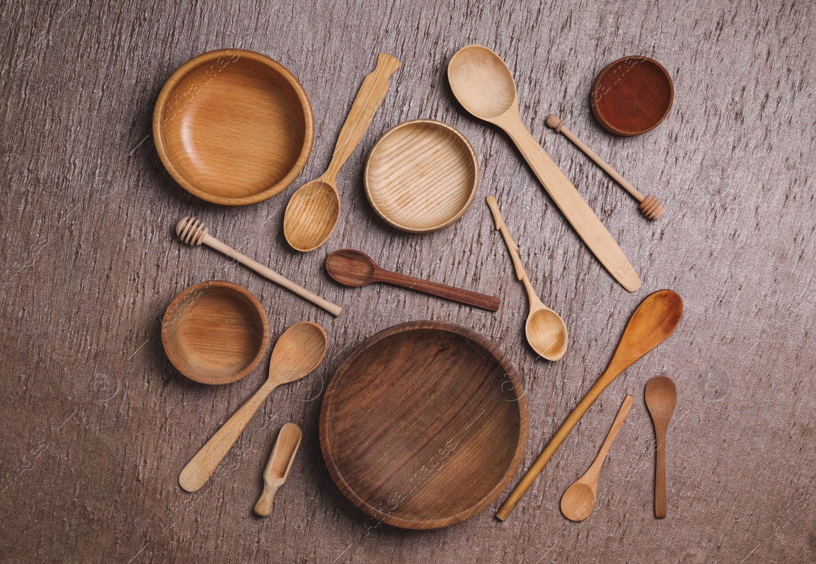 Photo of Set of clean cooking utensils on wooden table, flat lay